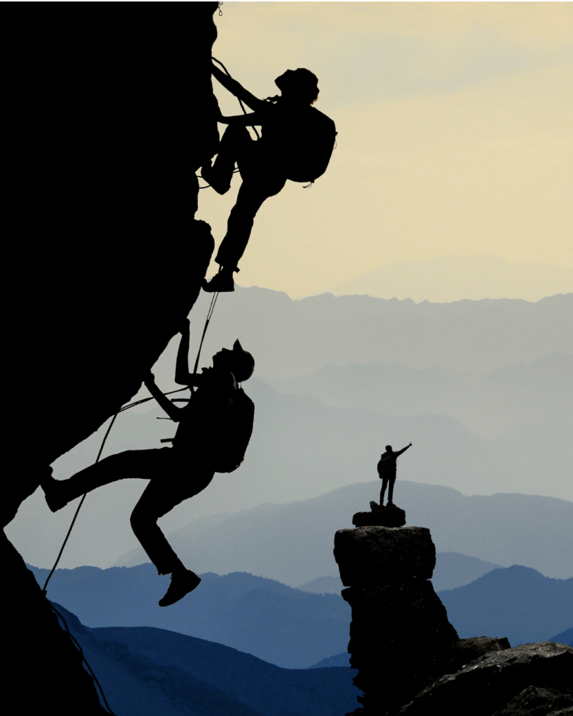 Climber silhouetted on a steep rock , demonstrating the control and body strength developed through rock climbing strength training